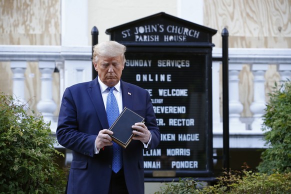 President Donald Trump holds a Bible as he visits outside St. John&#039;s Church across Lafayette Park from the White House Monday, June 1, 2020, in Washington. Part of the church was set on fire duri ...