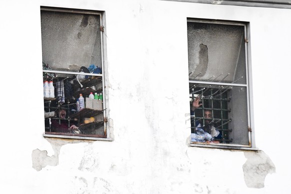 epa08337474 Inmates protest inside the Poggioreale prison in Naples, southern Italy, 01 April 2020. The inmates protested using pots and pans as drums and shouted from behind the bars &#039;We want fr ...