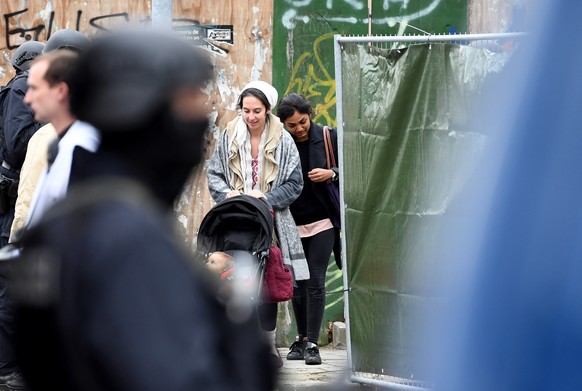 epa07907766 Visitors leave a synagogue after a shooting in Halle, Germany, 09 October 2019. According to the police two people were killed in shootings in front of a Synagogue and a Kebab shop in the  ...