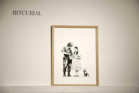 epa07116760 A serigraphy poster (Search and Stop-2007) of British artist Banksy prior to a sale at the french auction house Artcurial in Paris, France, 24 October 2018. EPA/CHRISTOPHE PETIT TESSON