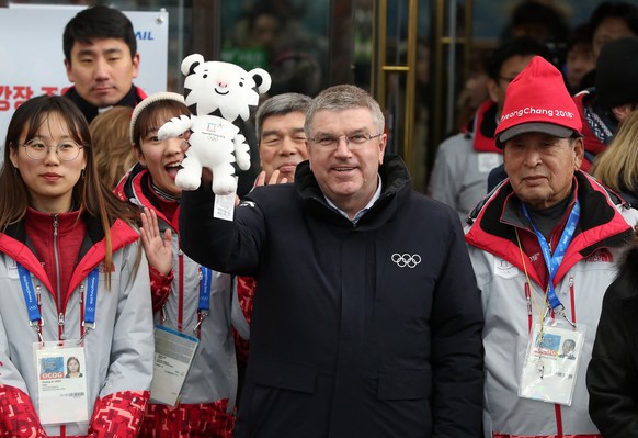 International Olympic Committee President Thomas Bach holds up the 2018 Pyeongchang Winter Olympic mascot upon his arrival at Jinbu Station in Pyeongchang, Tuesday, Jan. 30, 2018. South Korea on Tuesd ...