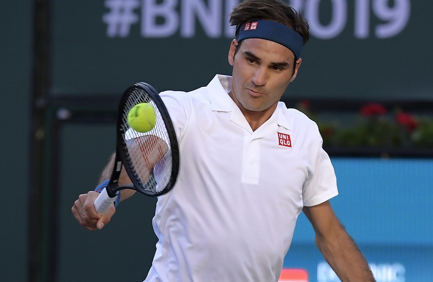 Roger Federer, of Switzerland, returns a shot to Dominic Thiem, of Austria, during the men&#039;s final at the BNP Paribas Open tennis tournament Sunday, March 17, 2019, in Indian Wells, Calif. (AP Ph ...