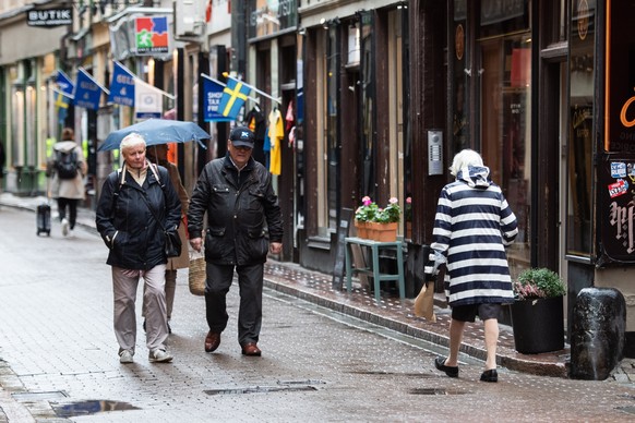 epa08764629 Elderly people stroll in the Old Town of Stockholm, Sweden, 22 October 2020. The Swedish government and the Public Health Agency removed specific coronavirus pandemic recommendations for p ...