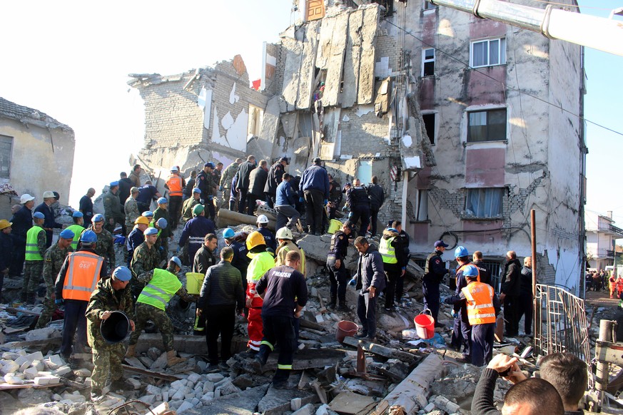 epa08026420 Rescue te4ams, army and police search for survivors in the rubble of a building after an earthquake hit Thumane, Albania, 25 November 2019. Albania was hit by a 6.4 magnitude earthquake on ...