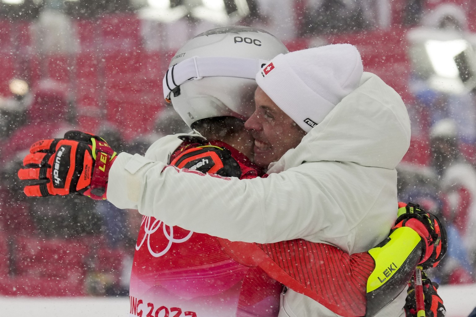 Marco Odermatt, of Switzerland, celebrates with a teammate winning the gold medal in the men&#039;s giant slalom at the 2022 Winter Olympics, Sunday, Feb. 13, 2022, in the Yanqing district of Beijing. ...