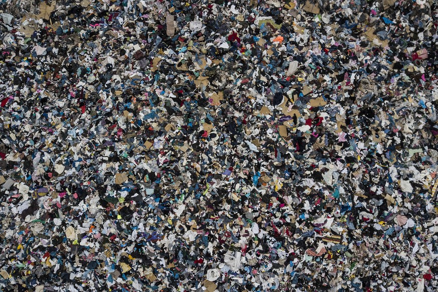 View of a mountain of discarded used clothing near La Mula neighborhood of Alto Hospicio, Chile, Sunday, Dec. 12, 2021. (AP Photo/Matias Delacroix)