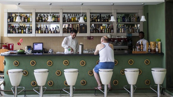 In this Sept. 12, 2017, photo, a customer sits at the lobby bar of the Hotel Capri in Havana, Cuba. New details about a string of mysterious “health attacks” on U.S. diplomats in Cuba indicate the inc ...