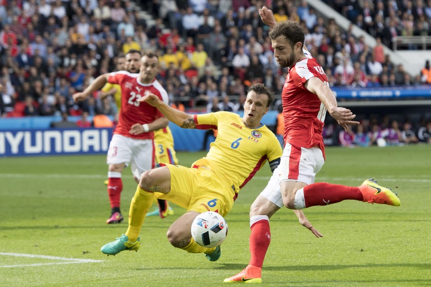 RomaniaÕs defender Vlad Chiriches, left, fights for the ball with Swiss midfielder Admir Mehmedi, right, during the UEFA EURO 2016 group A preliminary round soccer match between Romania and Switzerlan ...