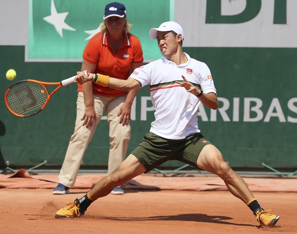 Japan&#039;s Kei Nishikori plays a shot in his second round match against France&#039;s Jeremy Chardy at the French Open tennis tournament at the Roland Garros stadium, in Paris, France. Thursday, Jun ...