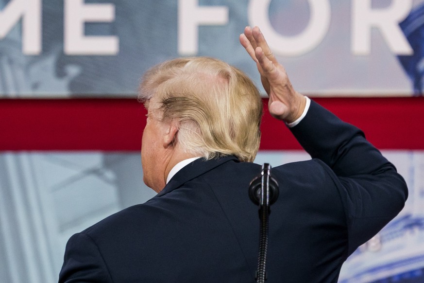 epa08703002 (FILE) - US President Donald J. Trump pretends to fix his hair as he addresses the 45th annual Conservative Political Action Conference (CPAC) at the Gaylord National Resort &amp; Conventi ...