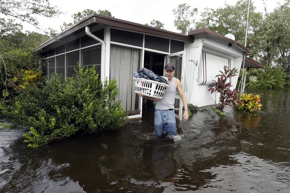 Grady Howell, of Plant City, Fla., helps a friend salvage items from a flooded mobile home Monday, Sept. 11, 2017, after Hurricane Irma moved through the area in Lakeland, Fla. (AP Photo/Chris O&#039; ...