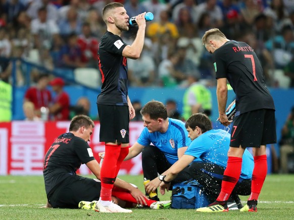 epa06856351 Mario Mandzukic (L) of Croatia receives medical assistance during the FIFA World Cup 2018 round of 16 soccer match between Croatia and Denmark in Nizhny Novgorod, Russia, 01 July 2018.

 ...