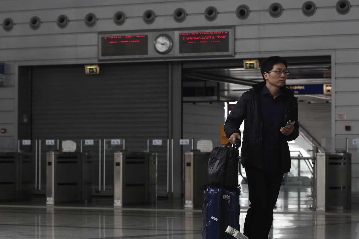 epa10502591 A commuter walks past the closed entrance to a suburban train station during a 48-hour strike announced by railway unions against the conditions of the country's railway network, days ...