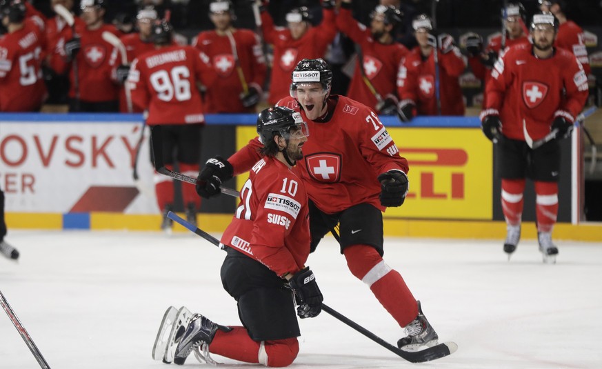 Switzerland&#039;s Andres Ambuhl, left, celebrates with teammate Joel Genazzi, right, after scoring his sides second goal during the Ice Hockey World Championships group B match between Switzerland an ...