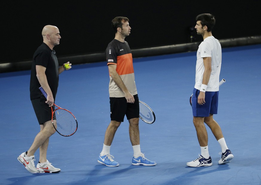 epa06434678 Novak Djokovic of Serbia (R) and his coaches Andre Agassi (L) of the USA and Radek Stepanek (C) of the Czech Republic during a training session at the Australian Open Grand Slam tennis tou ...