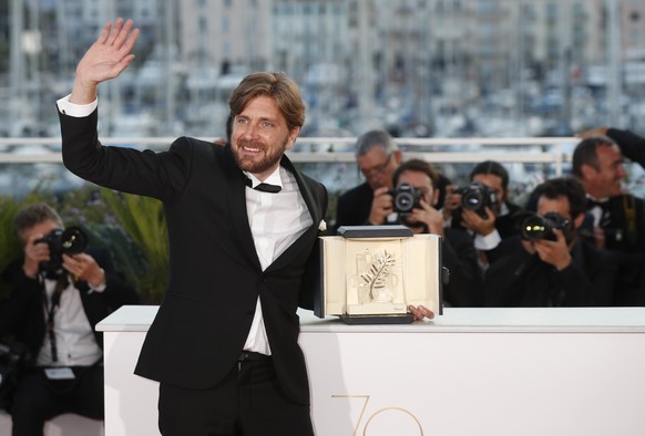 Director Ruben Ostlund with his Palme d&#039;Or award for his film The Square poses for photographers during a photo call following the awards ceremony at the 70th international film festival, Cannes, ...