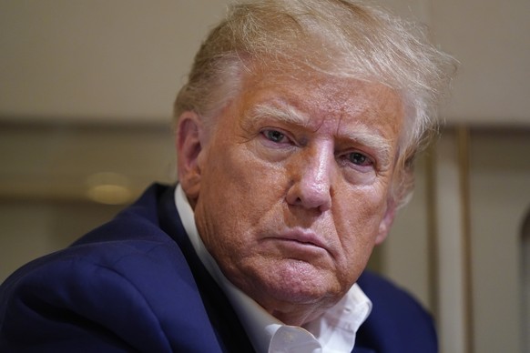 Former President Donald Trump listens as he speaks to reporters on the flight on his plane after a campaign rally at Waco Regional Airport, in Waco, Texas, Saturday, March 25, 2023, while en route…