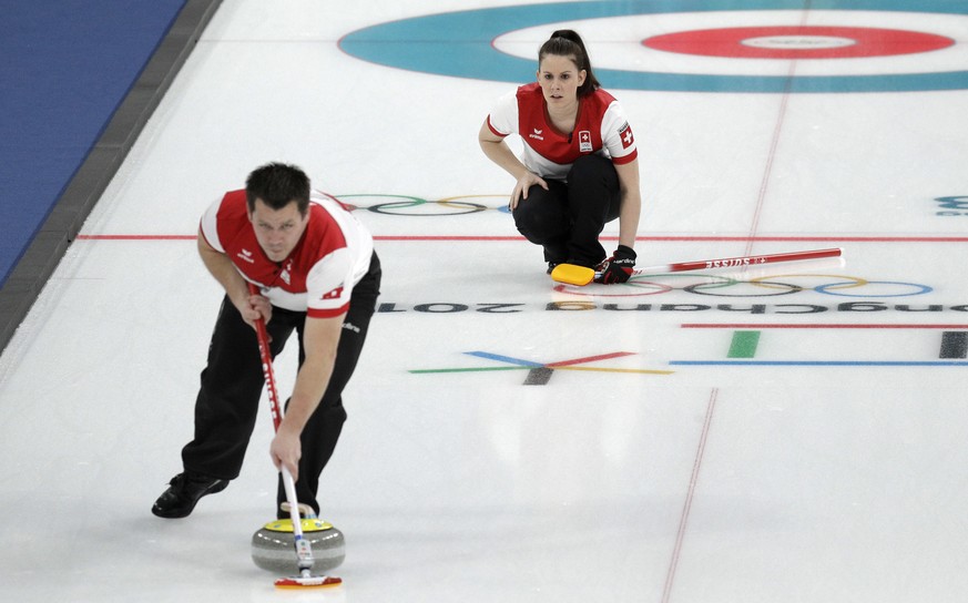 Switzerland Jenny Perret,right, and Martin Rios play during their mixed doubles curling finals match against Canada at the 2018 Winter Olympics in Gangneung, South Korea, Tuesday, Feb. 13, 2018. Canad ...