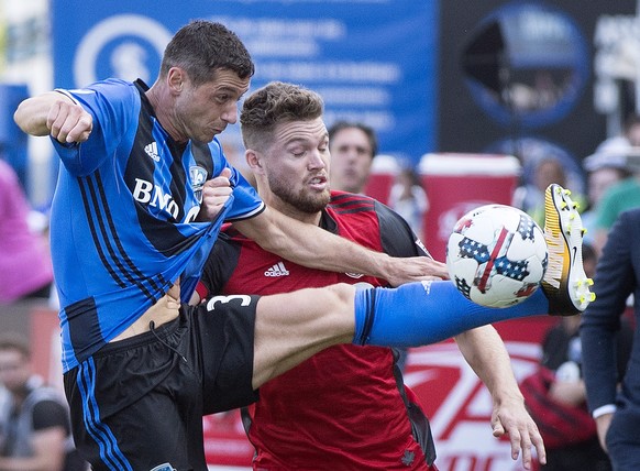 Montreal Impact&#039;s Blerim Dzemaili, left, challenges Toronto FC&#039;s Eriq Zavaleta during first half MLS soccer action in Montreal, Sunday, Aug. 27, 2017. (Graham Hughes/The Canadian Press via A ...