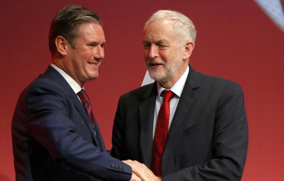 epa08342489 (FILE) - Britain's opposition Labor party then spokesman for leaving the EU Keir Starmer (L) is congratulated after his speech by then party leader Jeremy Corbyn (R) at the L...