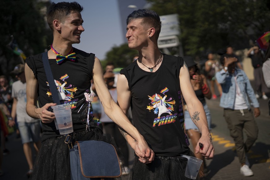 A couple exchange glances during the annual Gay Pride event in Johannesburg, South Africa, Saturday Oct. 26, 2019. Thousands took part in this 30th edition of Gay Pride. (AP Photo/Jerome Delay)