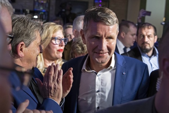 Bjoern Hoecke, chairman of the far-right Alternative fuer Deutschland (AfD) in Thuringia and top candidate of the party for the state elections, third of right, celebrates together with supporters aft ...