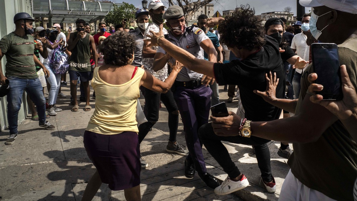 Police detain an anti-government demonstrator during a protest in Havana, Cuba, Sunday July 11, 2021. Hundreds of demonstrators went out to the streets in several cities in Cuba to protest against ong ...