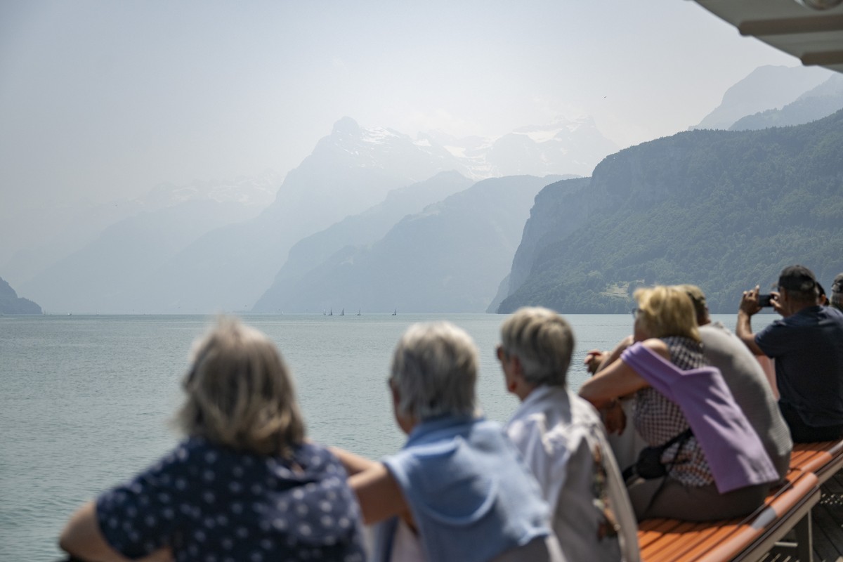 A haze of smoke from Canadian wildfires blankets the sky and mountains at the Urnersee in Brunnen, Switzerland, Wednesday, June 11, 2025. The smoke, originating from wildfires in Manitoba and Saskatch ...