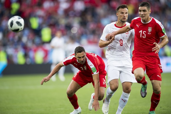 Serbia&#039;s defender Dusko Tosic, left, and Serbia&#039;s defender Nikola Milenkovic, right, fight for the ball with Switzerland&#039;s forward Haris Seferovic, center, during the FIFA World Cup 201 ...