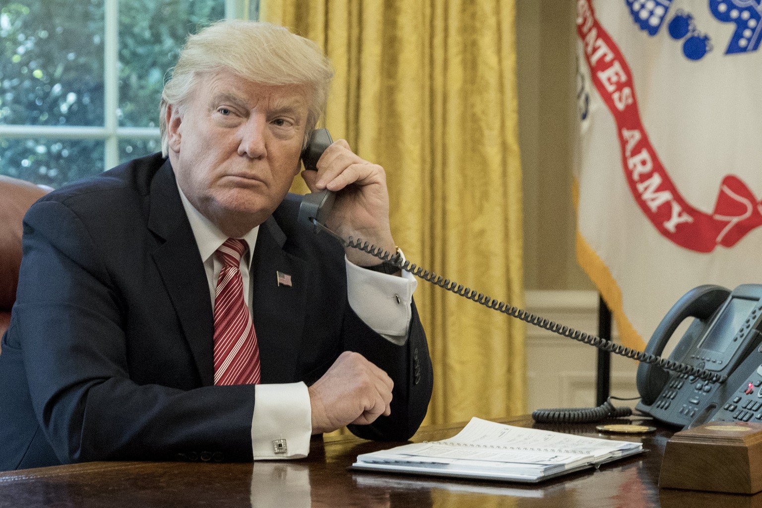 epa06052937 US President Donald J. Trump makes a phone call to Prime Minister of Ireland to Leo Varadkar in the Oval Office of the White House in Washington, DC, USA, 27 June 2017. EPA/MICHAEL REYNOLD ...