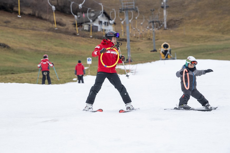 Skiers enjoy themselves on artificial snow, in Airolo Luina, Ticino, Switzerland, Sunday, December 21, 2025. All areas of the Swiss Alps currently have below-average snowfall for this time of year. (K ...