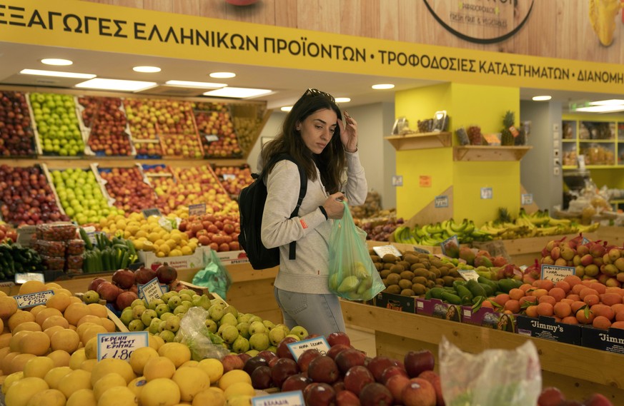 Personal trainer Antonia Kalantzi, 38, shops at a grocery store in Athens, Greece, Wednesday, Feb. 16, 2022. Economists, farmers and charity workers agree about a cost-of-living crisis in Europe: Infl ...