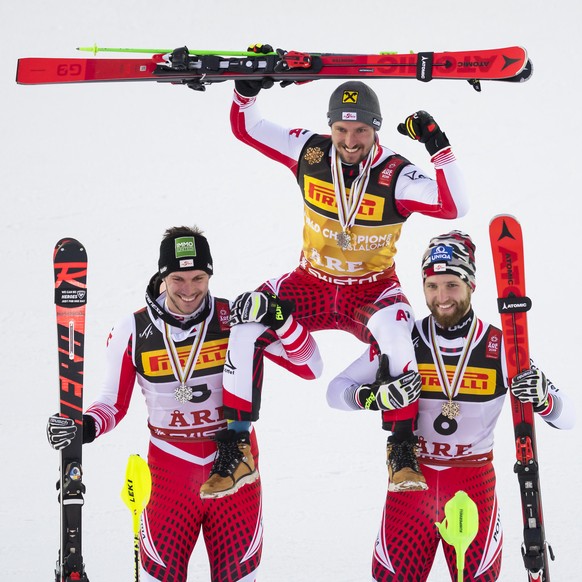 Michael Matt of Austria, left, silver medal, Marcel Hirscher of Austria, center, gold medal, Marco Schwarz of Austria, right, bronze medal, celebrate during the medals ceremony after the second run of ...