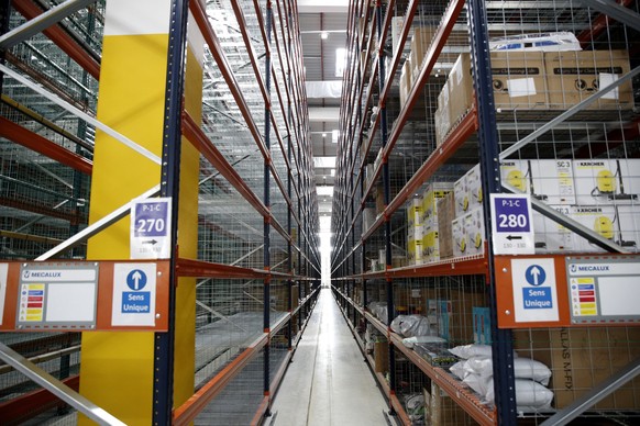 epa06242671 A general view of packaging stations during the visit of French President Macron (not pictured), at the Amazon logistics centre in Boves, near Amiens, France, 03 October 2017. French Presi ...