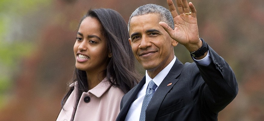 FILE - In this April 7, 2016 file photo, President Barack Obama and his daughter Malia, walk across the South Lawn of the White House in Washington before boarding Marine One helicopter for the short  ...