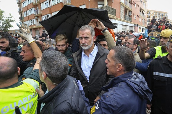 Spain&#039;s King Felipe VI is protected after a crowd of angry survivors of Spain&#039;s floods have tossed mud and shouted insults at the King and government officials when they made their first vis ...