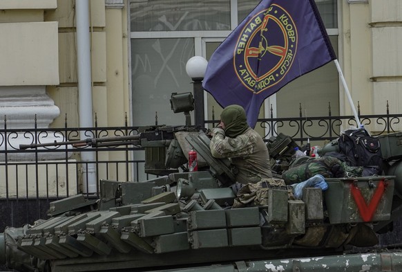 epa10709297 A serviceman from private military company (PMC) Wagner Group on a tank blocks a street in Rostov-on-Don, southern Russia, 24 June 2023. Security and armoured vehicles were deployed after  ...