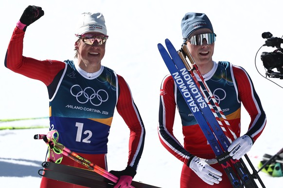 epa12753266 Johannes Hoesflot Klaebo (L) of Norway and Einar Hedegart of Norway react in the finish area after the Men's Team Sprint Free of the Cross-Country Skiing competitions at the Milano Co ...