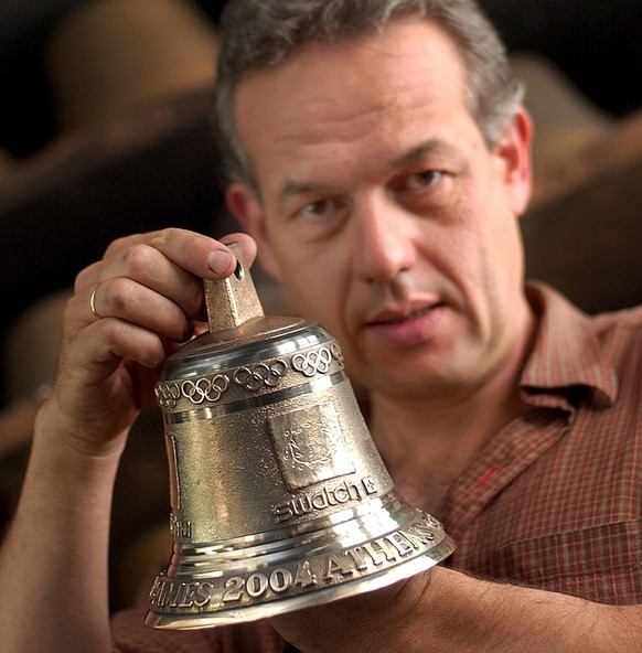 Serge Huguenin, bell founder, holds one of 30 bells ordered by Swatch, official timekeeper at the Olympic Games 2004 in Athens, for announcing the last rounds of long distance and cycling competitions ...