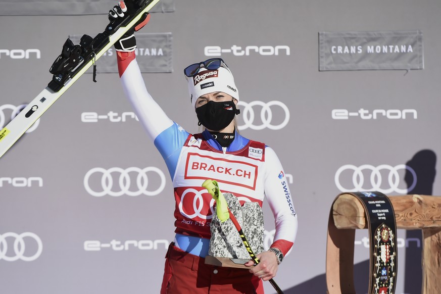 Switzerland's Lara Gut-Behrami celebrates winning an alpine ski, women's World Cup super-G, in Crans Montana, Switzerland, Sunday, Jan. 24, 2021. (AP Photo/Marco Tacca)