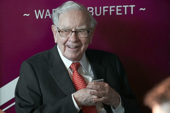 FILE - Warren Buffett, chairman and CEO of Berkshire Hathaway, smiles as he plays bridge following the annual Berkshire Hathaway shareholders meeting in Omaha, Neb., May 5, 2019. (AP Photo/Nati Harnik ...
