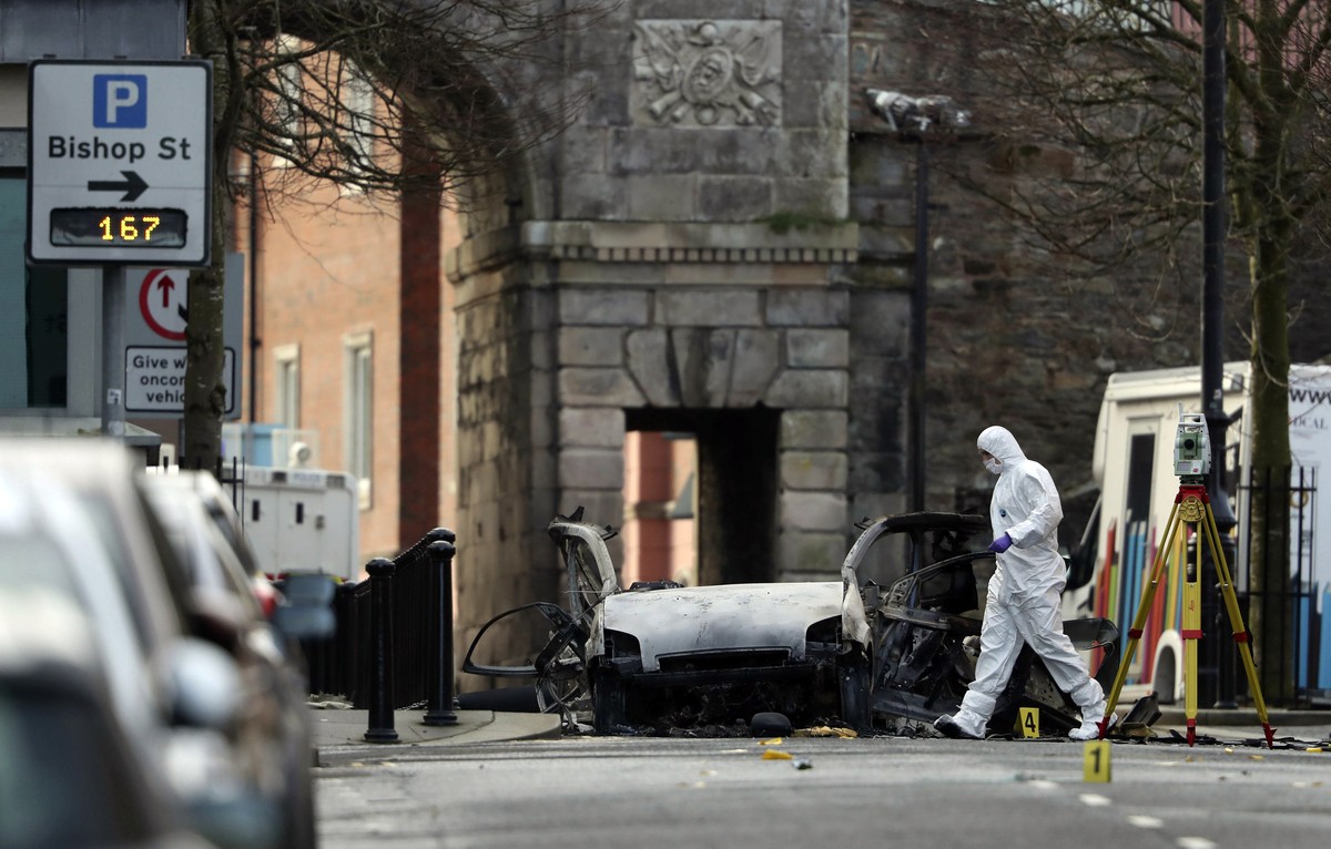Forensic investigators at the scene of a car bomb blast on Bishop Street in Londonderry, Northern Ireland, Sunday, Jan. 20, 2019. Northern Ireland police and politicians have condemned a "reckles ...