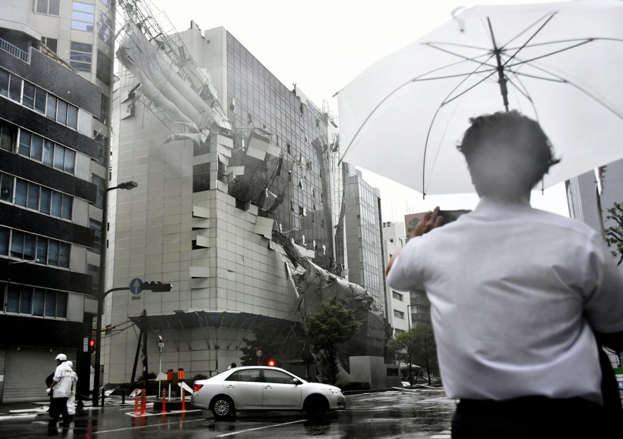 Scaffolding of a building being demolished, collapse, following a powerful typhoon in Osaka, western Japan, Tuesday, Sept. 4, 2018. A powerful typhoon blew through western Japan on Tuesday, causing he ...