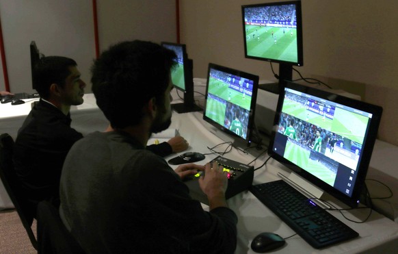 epa06220915 Two men work on the Video Arbitration Assistance (VAR) system as they participate in the closing of the first training of South American referees on VAR system, which will be used in Copa  ...