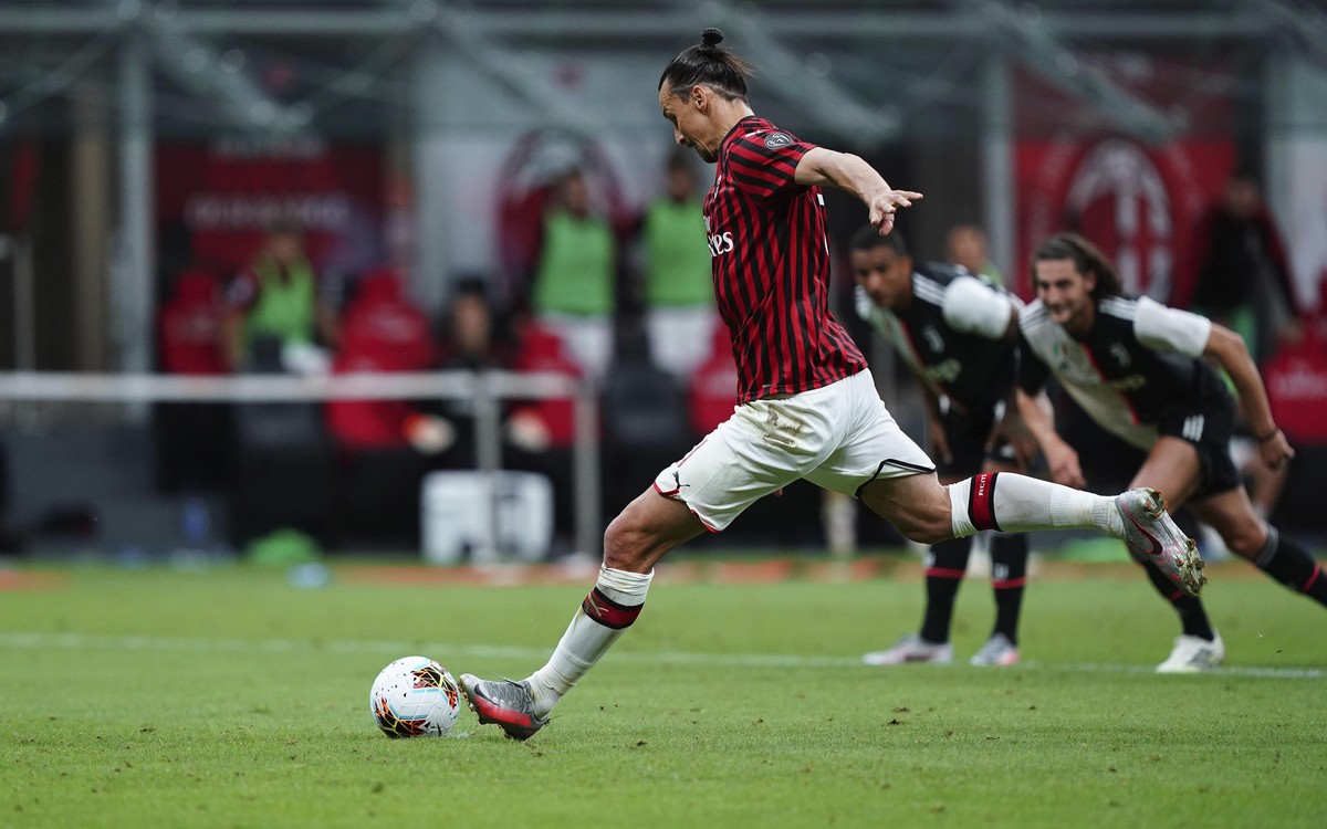 AC Milan's Zlatan Ibrahimovic scores from the penalty spot his side's opening goal during the Serie A soccer match between AC Milan and Juventus at the Milan San Siro Stadium, Italy, Tuesday ...