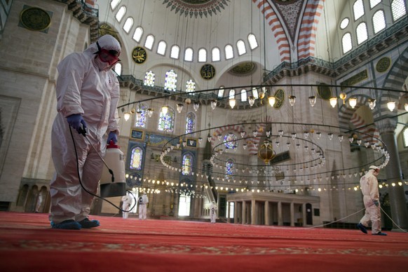 epa08444766 Fatih Municipality workers disinfects Suleymaniye Mosque before reopening on the last day of of the Eid al-Fitr in Istanbul, Turkey, 26 May 2020. On 29 May Turkey will partially open some  ...