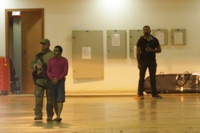 A federal police agent leads a handcuffed suspect who authorities say was arrested on terrorism-related charges in Brasilia, Brazil, Thursday, July 21, 2016. Ten Brazilians, who according to authoriti ...