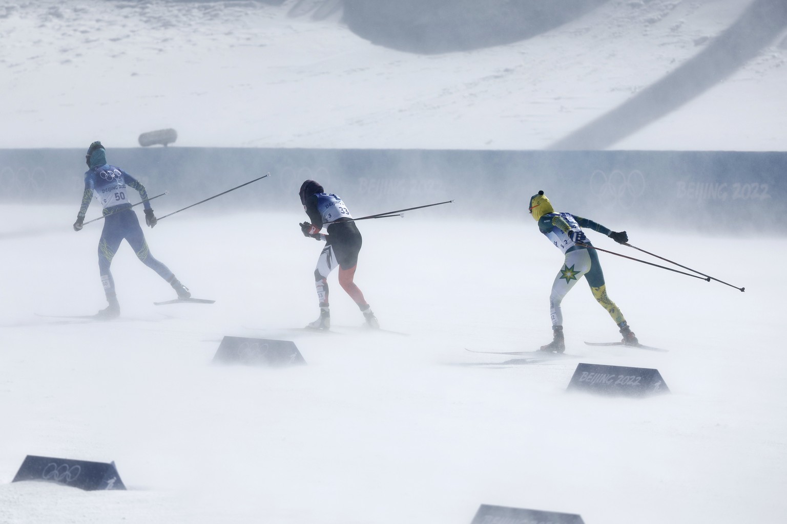 Angelina Shuryga of Kazakhstan, left, Dahria Beatty of Canada, center, and Jessica Yeaton of Australia in action during the women's cross-country skiing 30km Mass Start at the 2022 Winter Olympic ...