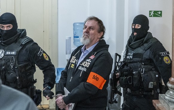 epa12469193 Juraj Cintula (2-R), the man accused of shooting the Slovak prime minister, is escorted by police for the main trial over the assassination attempt at the Specialized Criminal Court in Ban ...