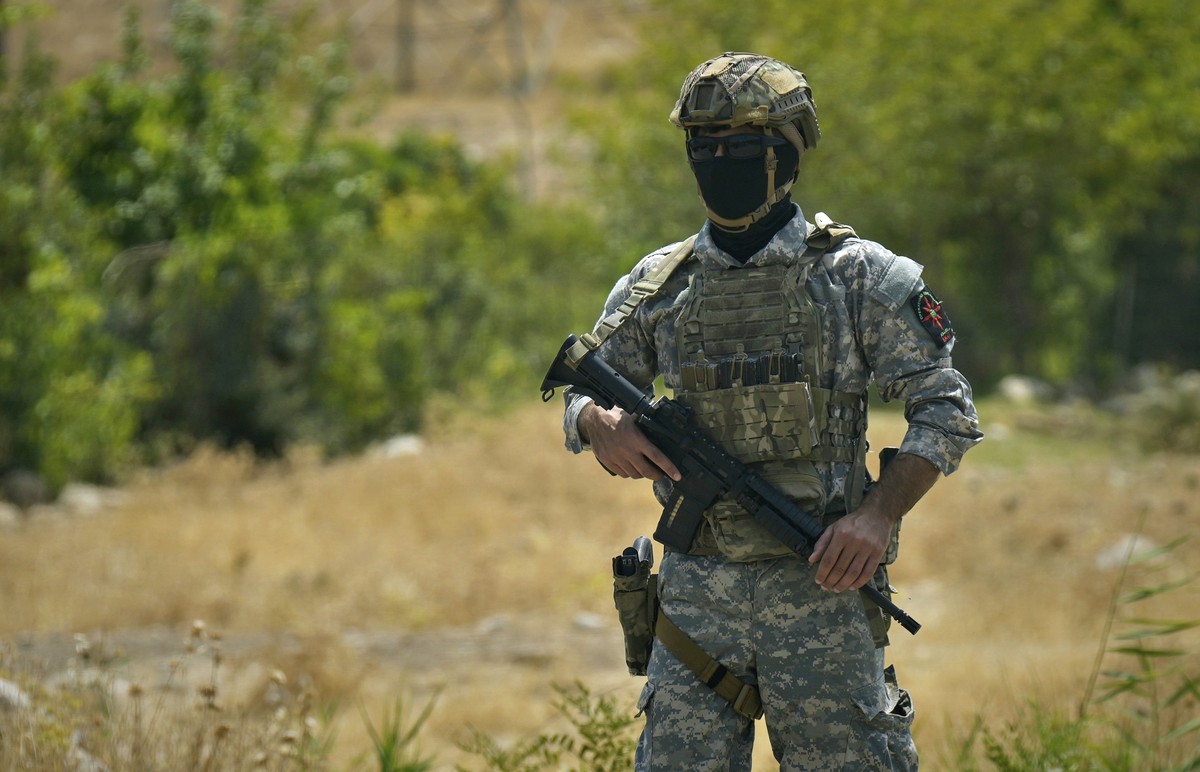 Forces of the regional Kurdish administration secure the area of the Jasana Cave ahead of a symbolic disarmament ceremony by the separatist PKK group as part of the peace process with Turkey, in Sulay ...